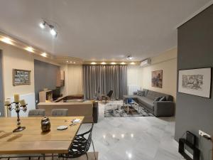 a large living room with a table and a couch at central luxury apartment in Volos