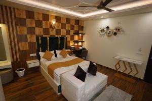 a bedroom with a bed and a chair in it at The Royal Hotel in Haldwāni +19 photos