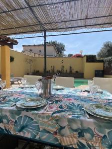 a table with plates and glasses on top at Sublime Maison Proche Mer Avec Piscine in Sanary-sur-Mer