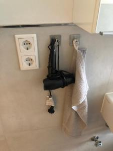 a bathroom with a towel dispenser on the wall at Zentrale Unterkunft in Dortmund City in Dortmund
