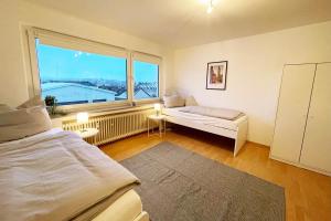 a bedroom with a bed and a large window at beautiful 2-room Apartment in Wuppertal