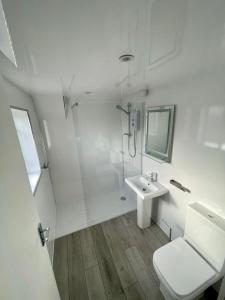 a white bathroom with a sink and a shower at Top Twenty Bed and Breakfast in Windsor