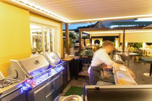 a man playing a video game in a restaurant at Restaurant Hotel Schrott in Kaibing