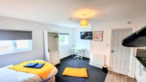 a bedroom with a bed and a desk in it at Burford Road - Stay. Sleep. Rest. in Nottingham