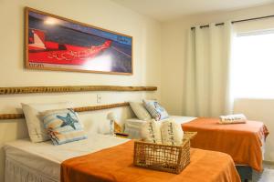 a hotel room with two beds and a couch at Casa Mar do Patacho in Pôrto de Pedras +32 photos