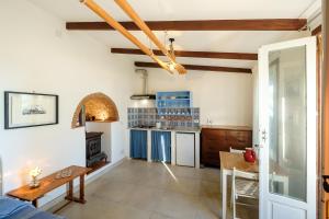 a kitchen with blue cabinets and a table at La rosa dei venti in Procida