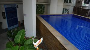 a swimming pool in the middle of a building at Sundowner Sukhumvit in Bangkok