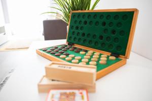 a green board with a calculator on a desk at O Cardanho dos Galfarritos - A Casa dos Miúdos in Aveiro