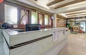 a lobby with a reception desk in a building at Om Sai Nath Hotel & Restaurant By WB Inn in Agra