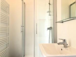 uma casa de banho com um lavatório e um chuveiro em Classic, Modern&Charming! 7min to Vienna’s center! em Viena