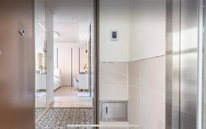 a bathroom with a glass door leading to a hallway at Urban Exit Studio Gangnam in Seoul