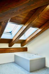 a bath tub in a room with wooden ceilings at Case Verdi in Bardonecchia