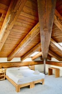 a bedroom with a bed and a wooden ceiling at Case Verdi in Bardonecchia