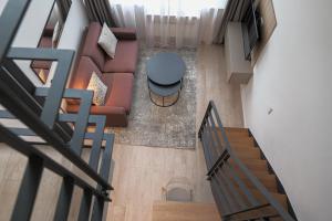 an overhead view of a living room with a couch and a table at Aparthotel Cosy in Stuttgart