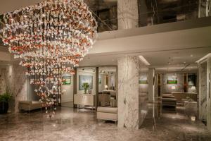 a large chandelier in the lobby of a hotel at Le Jardin Hotel Haute Couture in Hanoi