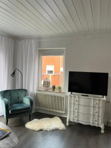 TV a/nebo společenská místnost v ubytování Quartier Lookvenne Wohnung 1