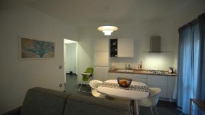 a living room with a table and a kitchen at Mi Tierra Luxury Apartments in Palermo