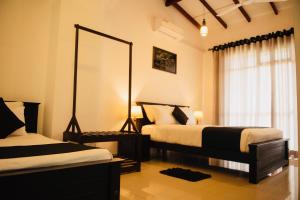 a bedroom with two beds and a large mirror at 49 Ella in Ella
