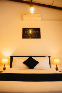 a bedroom with a large bed with two lamps at 49 Ella in Ella