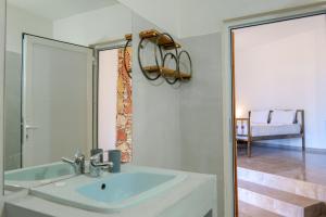 a bathroom with a sink and a mirror at John's Guesthouse in Ksamil