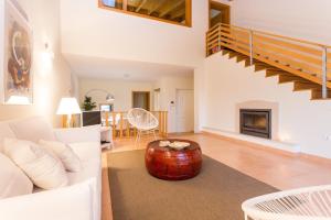 a living room with a couch and a coffee table at Villas T3 com Jardim Vila Sagres in Sagres