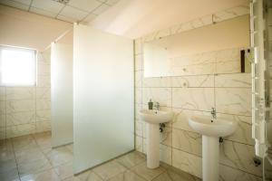 a bathroom with two sinks and a mirror at Si-Yo hostel in Uzhhorod