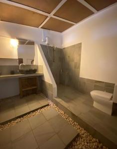a bathroom with a sink and a toilet and a sink at Samura Maldives Guest House Thulusdhoo in Thulusdhoo