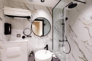 a bathroom with a sink and a mirror at Star Champs-Elys&eacute;es in Paris