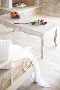 - une table en bois avec une assiette de fruits et de fleurs dans l'établissement Poliana Estate Villas, à Riglia