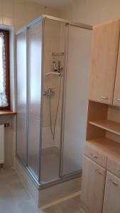 a shower with a glass door in a bathroom at Ferienwohnung Moosegger in Bad Feilnbach