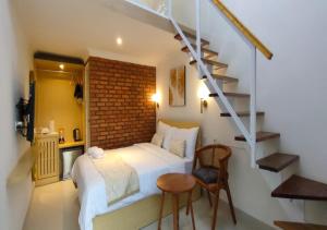 a bedroom with a bed and a brick wall at GSV Cottage Sharia in Bogor