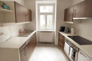 a kitchen with a sink and a window at Modern & Charming @ Villas quarter! 7min to Center in Vienna