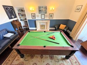 a living room with a pool table at Kirkhill Estate Rooms in Gorebridge