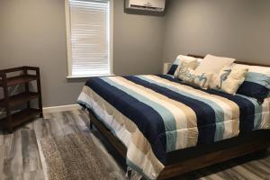 a bedroom with a bed with a blue and white blanket at Gem 3 in Jacksonville Beach
