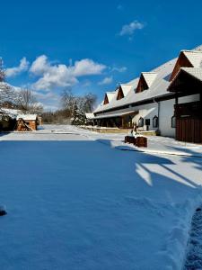 a parking lot covered in snow next to a building at Hotel Jiřičná in Sušice