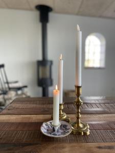 two candles are sitting on a wooden table at Vibæk in Sønderborg