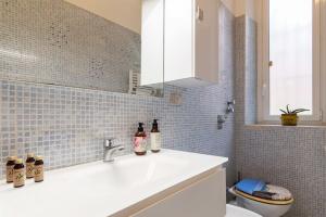 a bathroom with a white sink and a toilet at Piola Flexyrent apt. A.C. WiFi in Milan