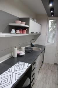 a kitchen with a counter top and a sink at Apartmani Borova Iglica Divčibare in Divčibare