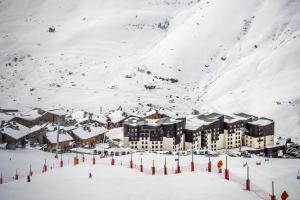 a resort in the snow on a mountain at Villages Clubs du Soleil - LES MENUIRES in Les Menuires