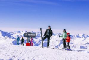 a group of people standing at the top of a snow covered mountain at Villages Clubs du Soleil - LES MENUIRES in Les Menuires