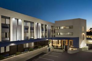 an exterior view of a building at night at Baymont by Wyndham Monterey Park in Monterey Park