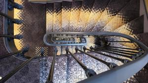 an overhead view of a stairwell with water running down it at Star Champs-Elysées in Paris