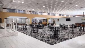 a large room with tables and chairs on a carpet at Motel 6 Hastings NE in Hastings