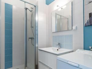 a bathroom with a shower and a sink and a mirror at Apartment Foncillon by Interhome in Royan