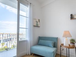 a living room with a couch and a large window at Apartment Foncillon by Interhome in Royan