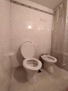 a bathroom with a toilet and a bidet at Welcome from Belgrano R Room in Buenos Aires +8 photos