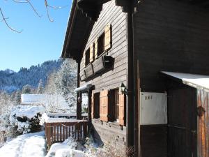a wooden house with snow on the side of it at Chalet Henri by Interhome in Moleson