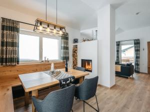 a dining room with a table and chairs and a fireplace at Chalet Mountain Lodge - Klippitztörl by Interhome in Klippitztorl