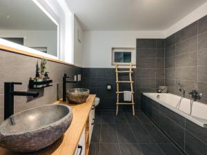 a bathroom with a large vessel sink and a tub at Chalet Mountain Lodge - Klippitztörl by Interhome in Klippitztorl