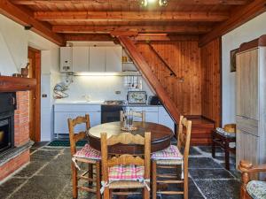 a kitchen with a wooden table and chairs at Holiday Home Il Crotto by Interhome in Pianello Del Lario